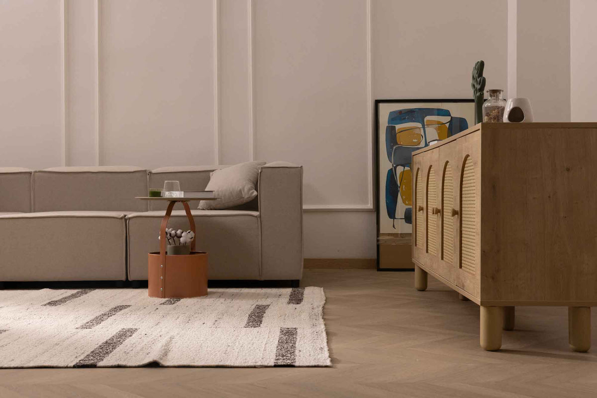 Handwoven white and brown wool-blend flatweave rug with a modern geometric pattern in a cozy living room.