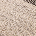 Close-up of a handwoven white and brown wool-blend flatweave rug with a textured, durable kilim design.