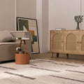 Handwoven white and brown wool-blend flatweave rug with a minimalist striped pattern in a modern living room.