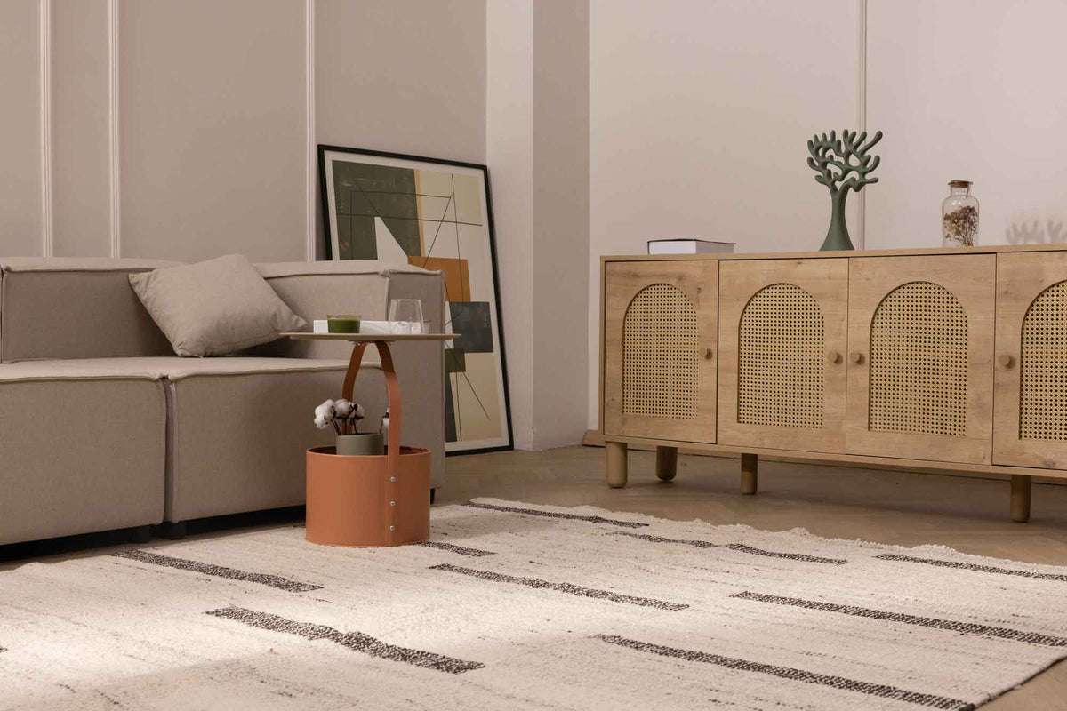 Handwoven white and brown wool-blend flatweave rug with a minimalist striped pattern in a modern living room.