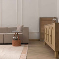 Apricot shaggy wool rug with a thick, textured pile in a cozy, modern living room setting with light wood furniture.
