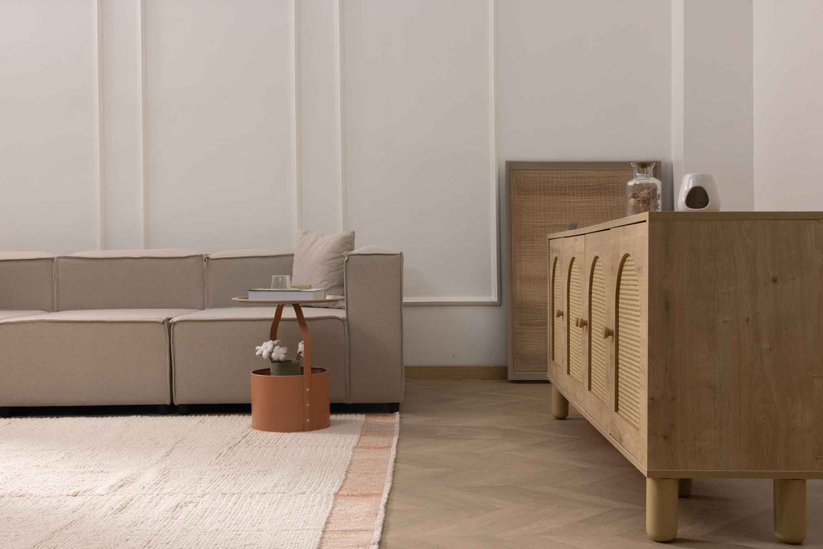 Apricot shaggy wool rug with a thick, textured pile in a cozy, modern living room setting with light wood furniture.