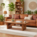 Soft apricot shaggy wool rug with a high-pile texture in a cozy, sunlit living room with wooden furniture.