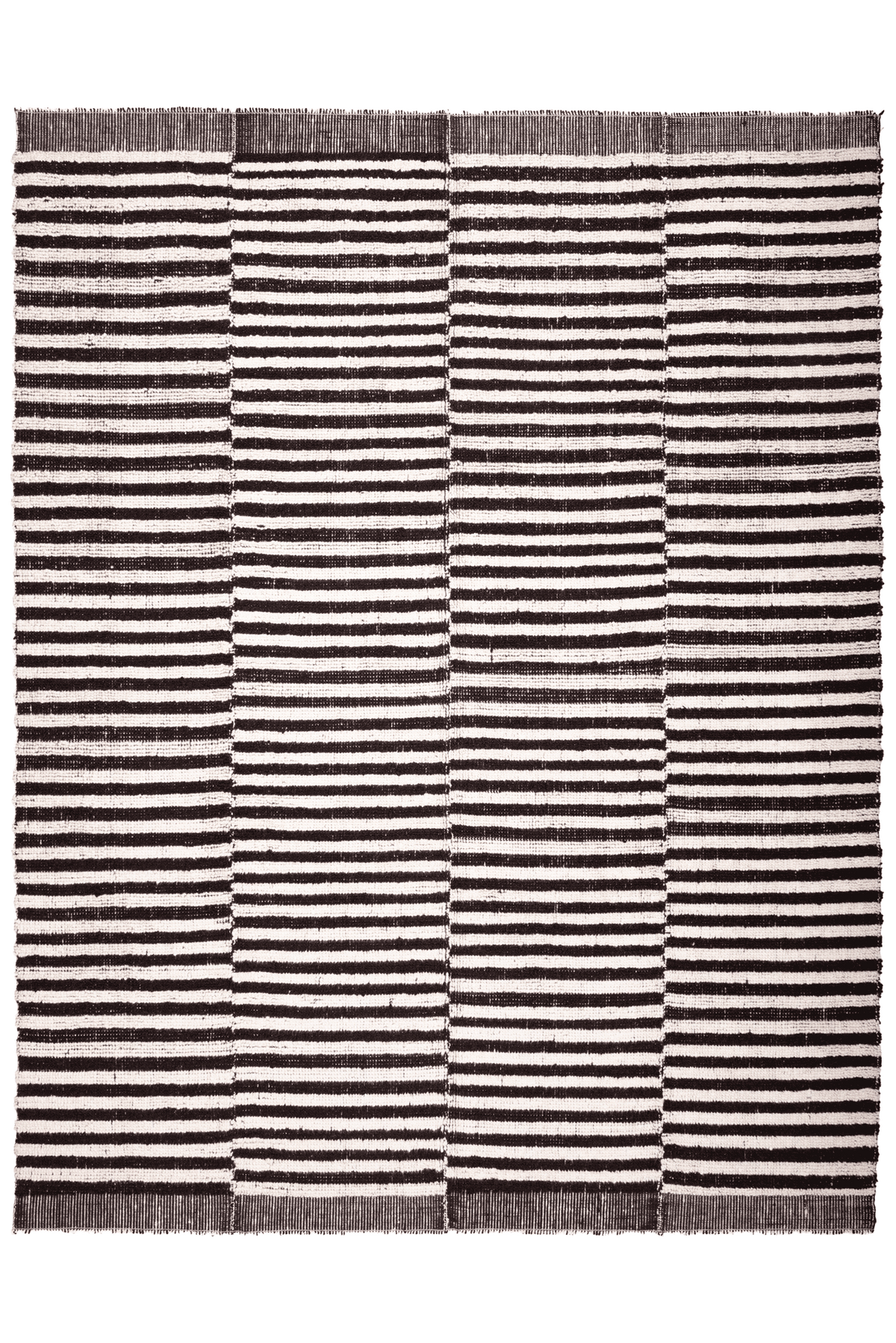 Handwoven black and white striped shaggy wool rug with a thick, textured pile and durable cotton blend construction.