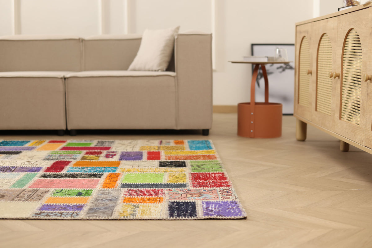 5x8 ft vintage Turkish patchwork area rug featuring vibrant, hand-stitched floral wool and cotton pieces in a bohemian style.
