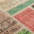 Handmade 5x8 ft vintage Turkish patchwork rug featuring colorful floral patterns in wool and cotton.
