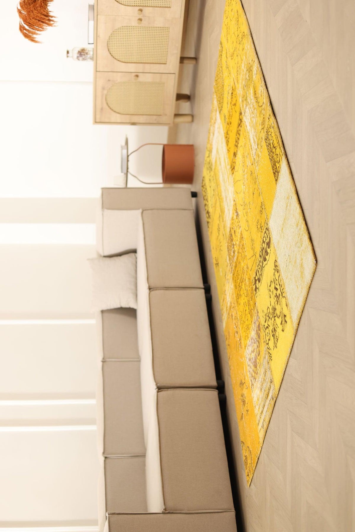 5x7 ft yellow patchwork Turkish area rug in wool and cotton with vintage overdyed patterns in a bohemian living room.