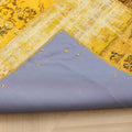 Vintage yellow patchwork Turkish area rug with a blue fabric backing and hand-stitched wool and cotton details.