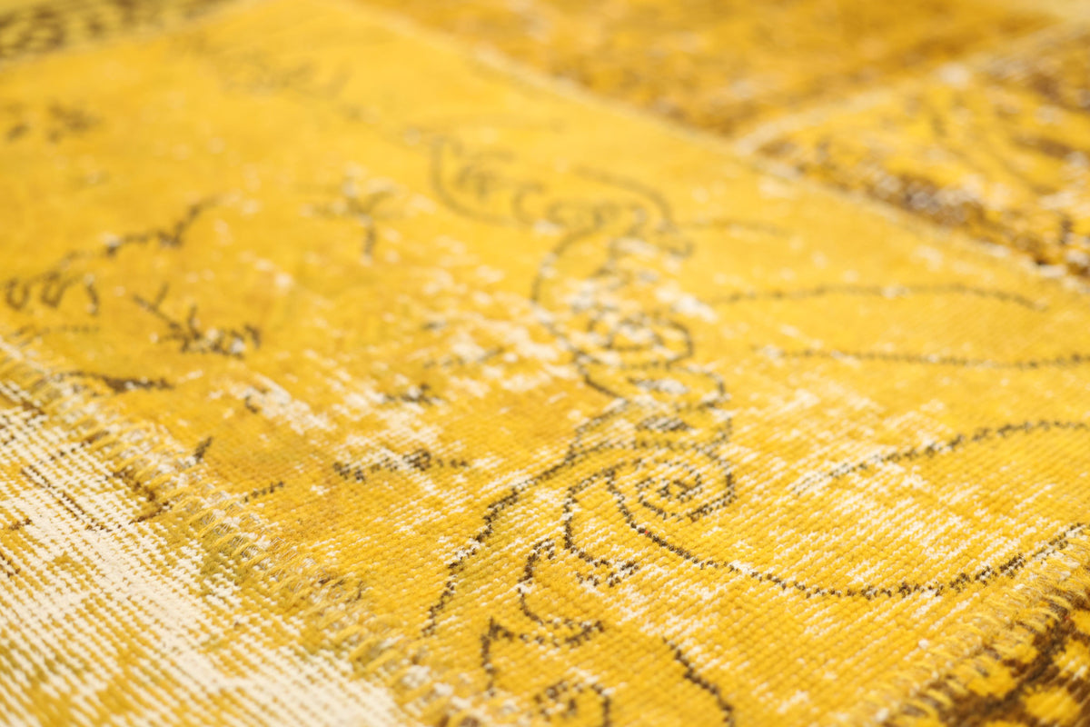 Handmade yellow patchwork Turkish area rug with overdyed vintage patterns in wool and cotton.
