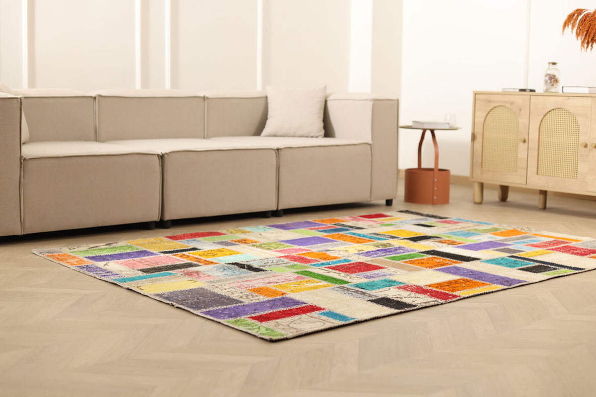 5x8 ft handmade Turkish patchwork area rug with vibrant multicolored floral patterns in wool and cotton.