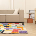 5x8 ft handmade patchwork Turkish area rug featuring vibrant, multicolored floral patterns in a bohemian style.