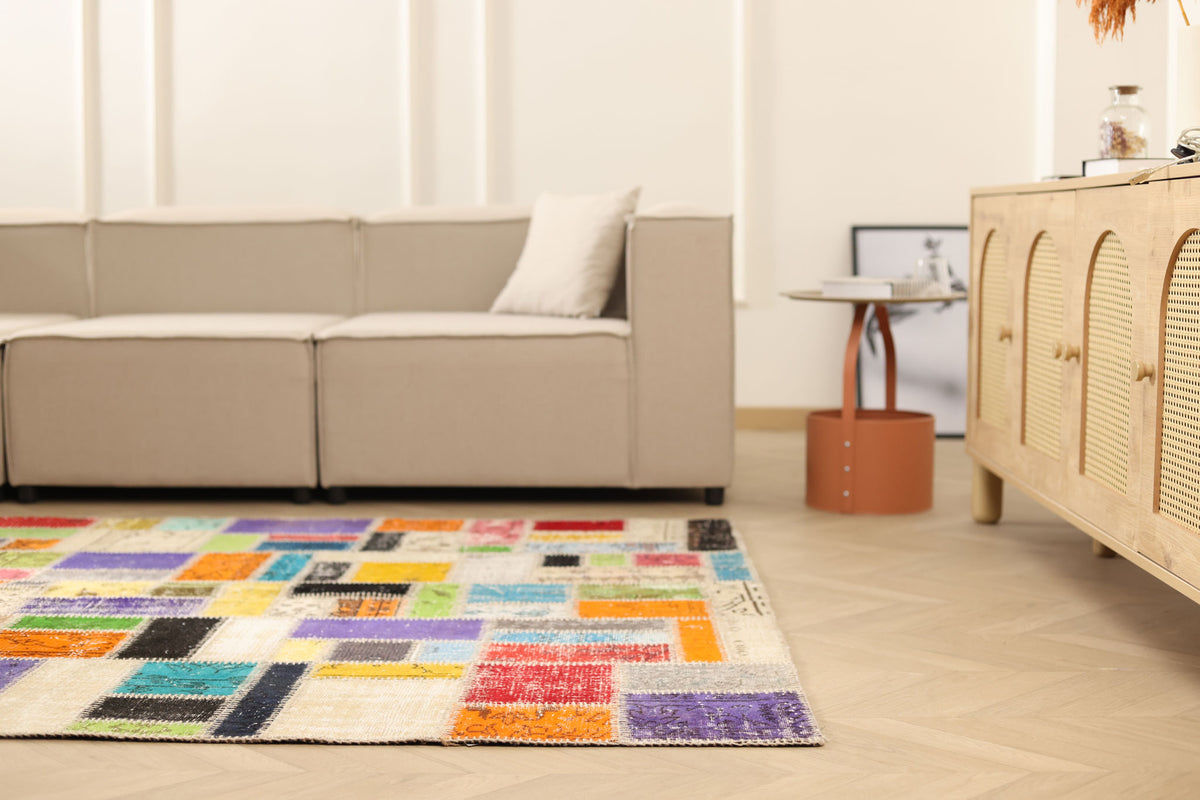 5x8 ft handmade patchwork Turkish area rug featuring vibrant, multicolored floral patterns in a bohemian style.