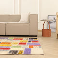 Handmade 5x8 ft vintage Turkish patchwork rug with vibrant, multicolored floral patterns in wool and cotton.