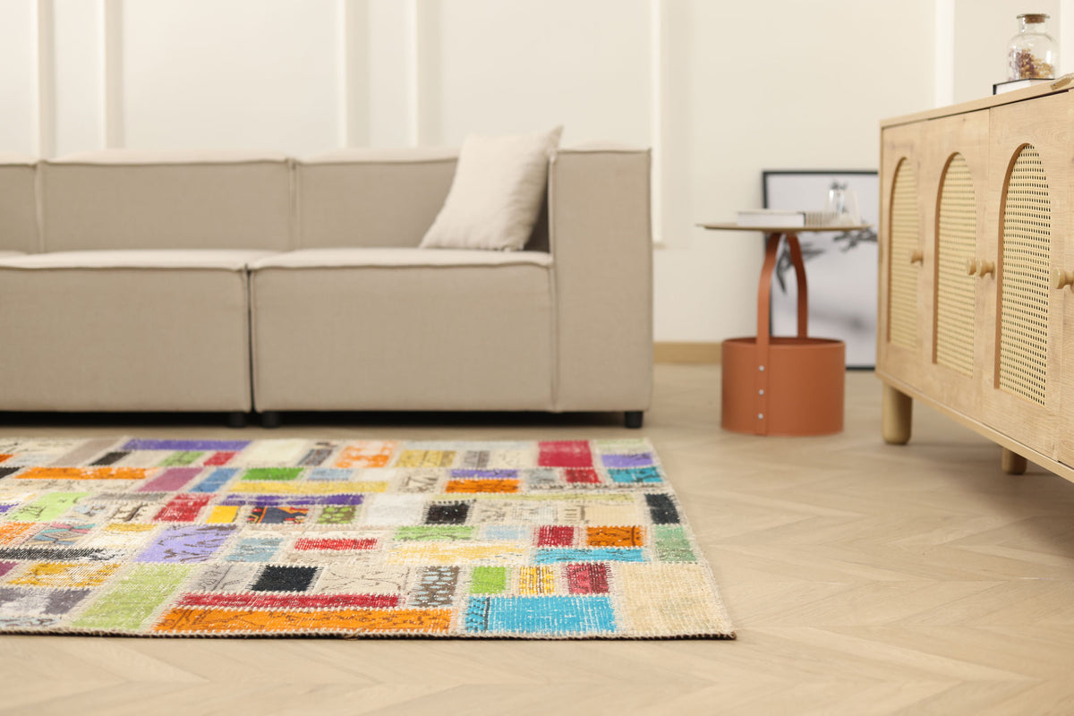 5x8 ft vintage Turkish patchwork area rug with vibrant, multi-colored floral wool and cotton patterns in a bohemian room.
