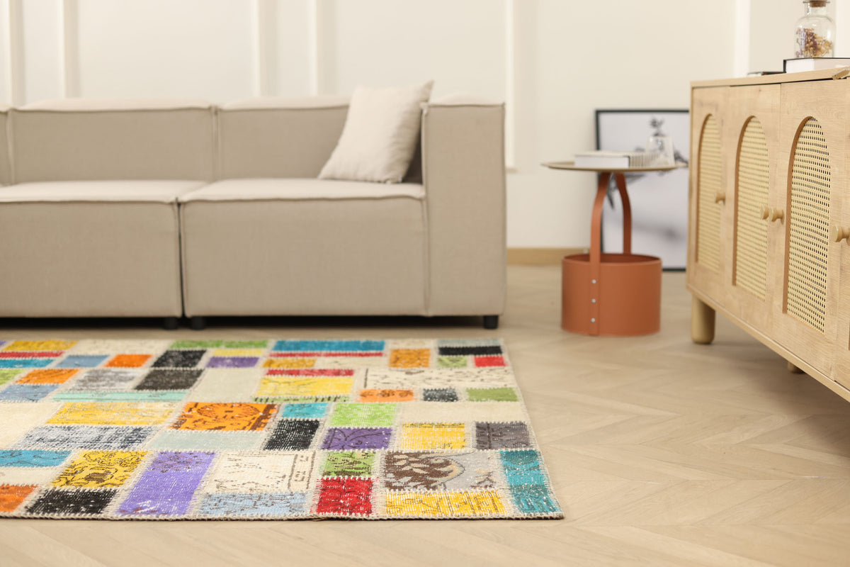 5x7 ft handmade Turkish patchwork area rug with vibrant, multicolored floral patterns in wool and cotton.