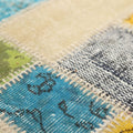 Handmade 5x7 patchwork Turkish area rug featuring vibrant wool and cotton floral patterns in a bohemian style.