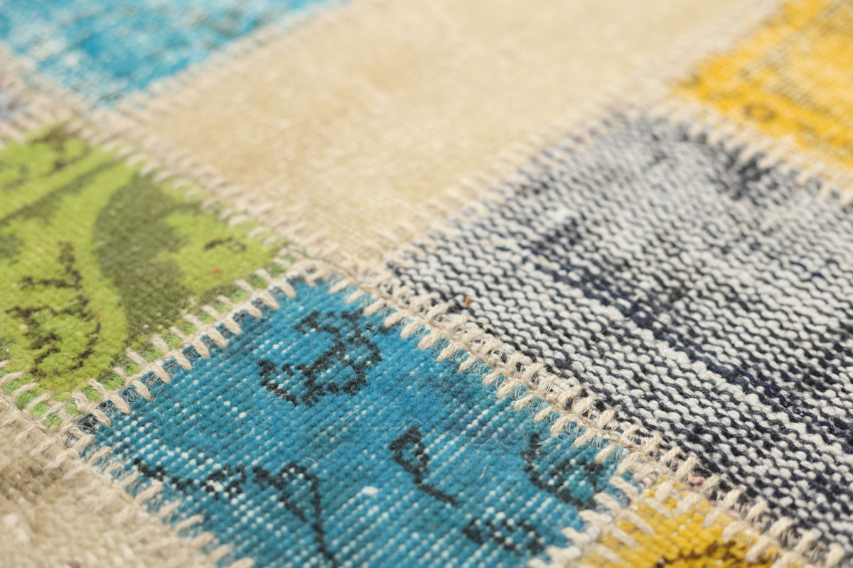 Handmade 5x7 patchwork Turkish area rug featuring vibrant wool and cotton floral patterns in a bohemian style.