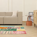 5x7 ft handmade patchwork Turkish area rug with vibrant floral patterns in wool and cotton, styled in a modern living room.
