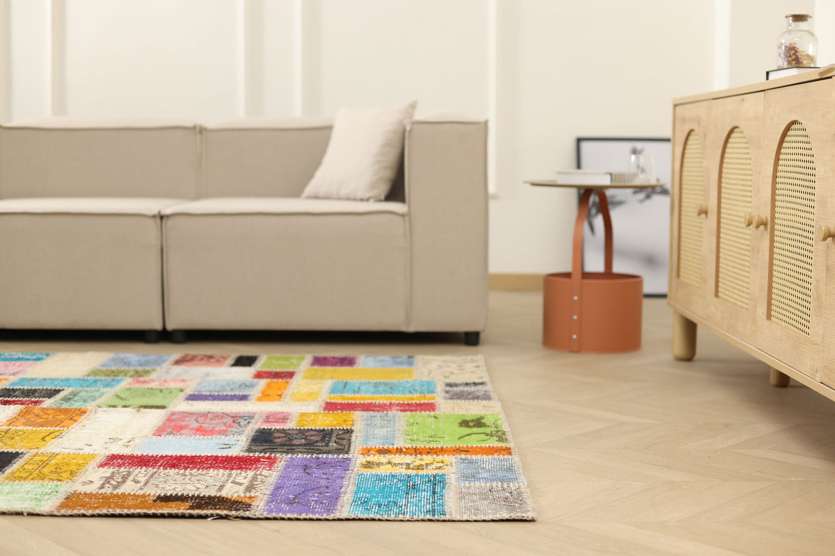 Handmade 5x7 ft vintage Turkish patchwork area rug with vibrant geometric patterns in wool and cotton.