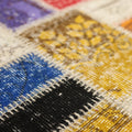Handmade Turkish patchwork rug with vibrant geometric wool and cotton squares in a bohemian style.