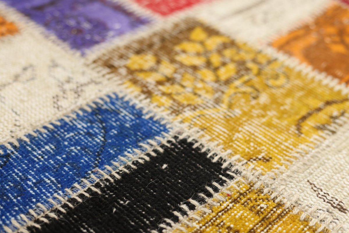 Handmade Turkish patchwork rug with vibrant geometric wool and cotton squares in a bohemian style.