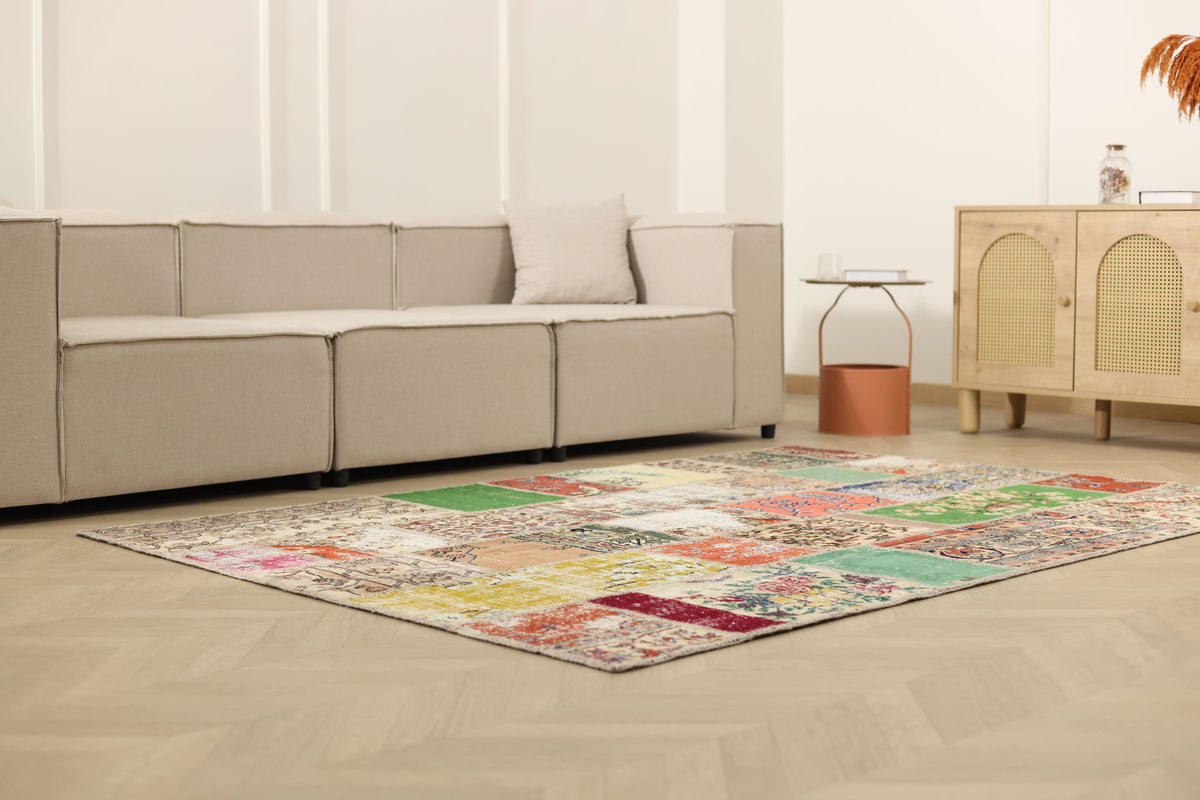 5x7 ft vintage Turkish patchwork area rug with vibrant floral patterns in wool and cotton, styled in a modern living room.