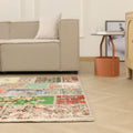 Handmade 5x7 patchwork Turkish rug with vibrant floral patterns in wool and cotton on a light wood floor.