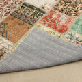 Handmade 5x7 ft patchwork Turkish area rug with vibrant floral patterns, wool and cotton blend, showing its grey fabric backing.