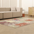5x7 ft handmade vintage Turkish patchwork area rug with vibrant floral patterns in wool and cotton on a wooden floor.