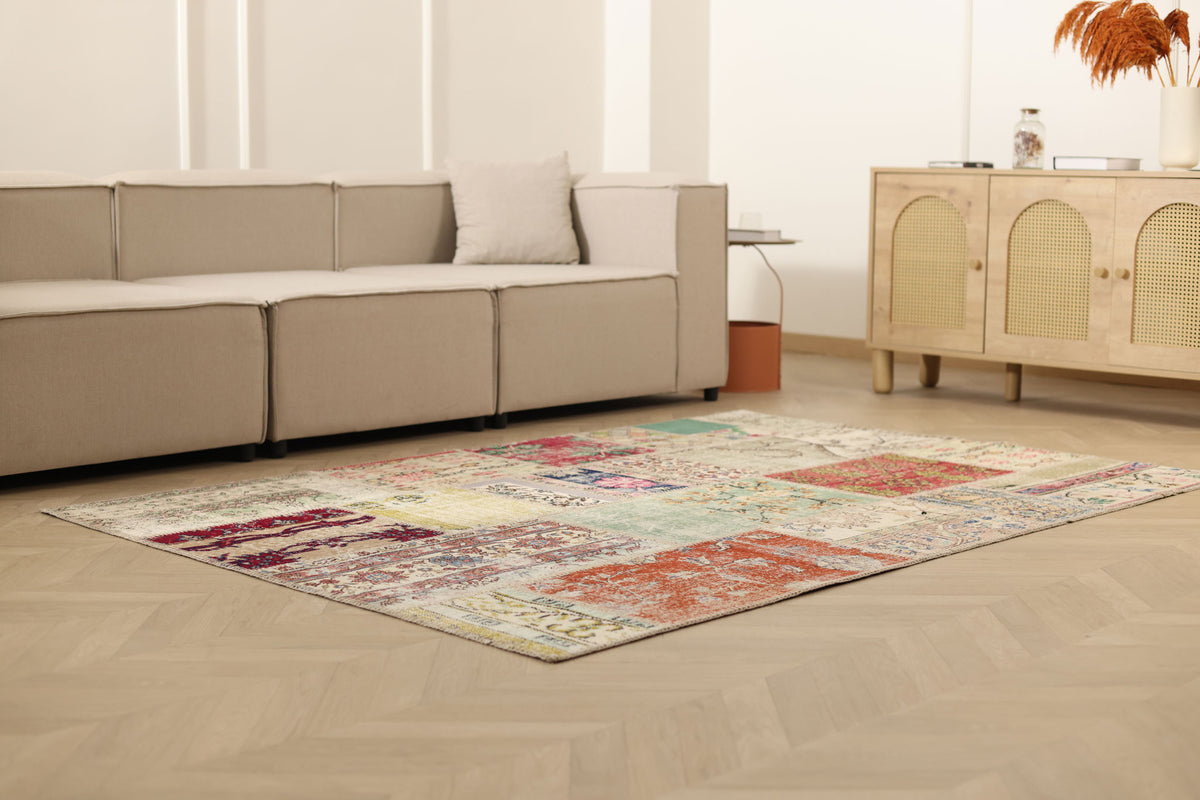 5x7 ft handmade vintage Turkish patchwork area rug with vibrant floral patterns in wool and cotton on a wooden floor.