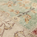 Handmade 5x7 patchwork Turkish rug with floral patterns in wool and cotton, featuring a vibrant, multi-colored vintage design.
