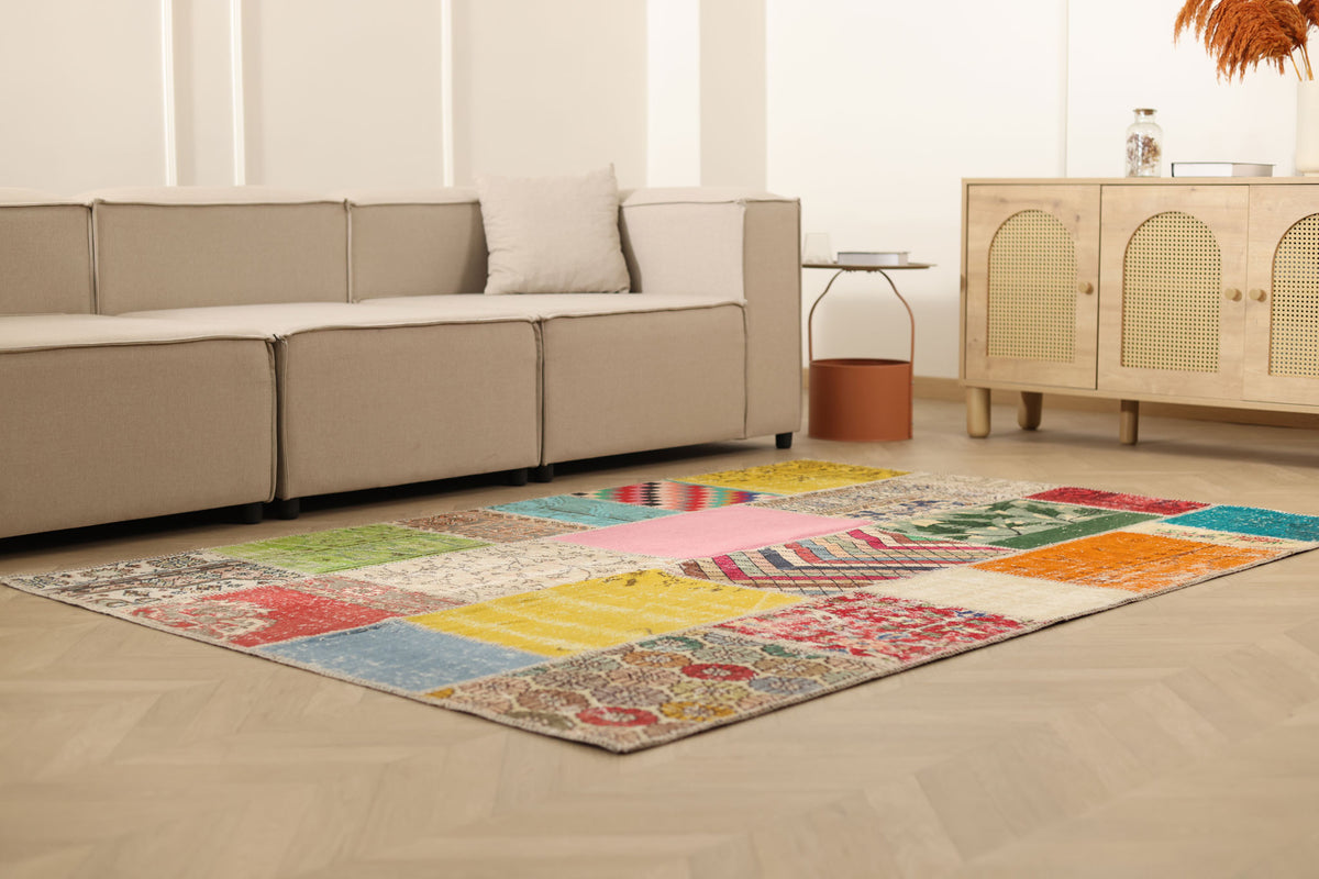 5x7 ft vintage Turkish patchwork area rug in wool and cotton with vibrant geometric patterns in a bohemian living room.