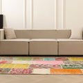 5x7 ft handmade Turkish patchwork area rug with vibrant geometric patterns in wool and cotton, styled in a modern living room.