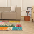 Handmade 5x7 ft vintage Turkish patchwork area rug with vibrant geometric patterns in wool and cotton.