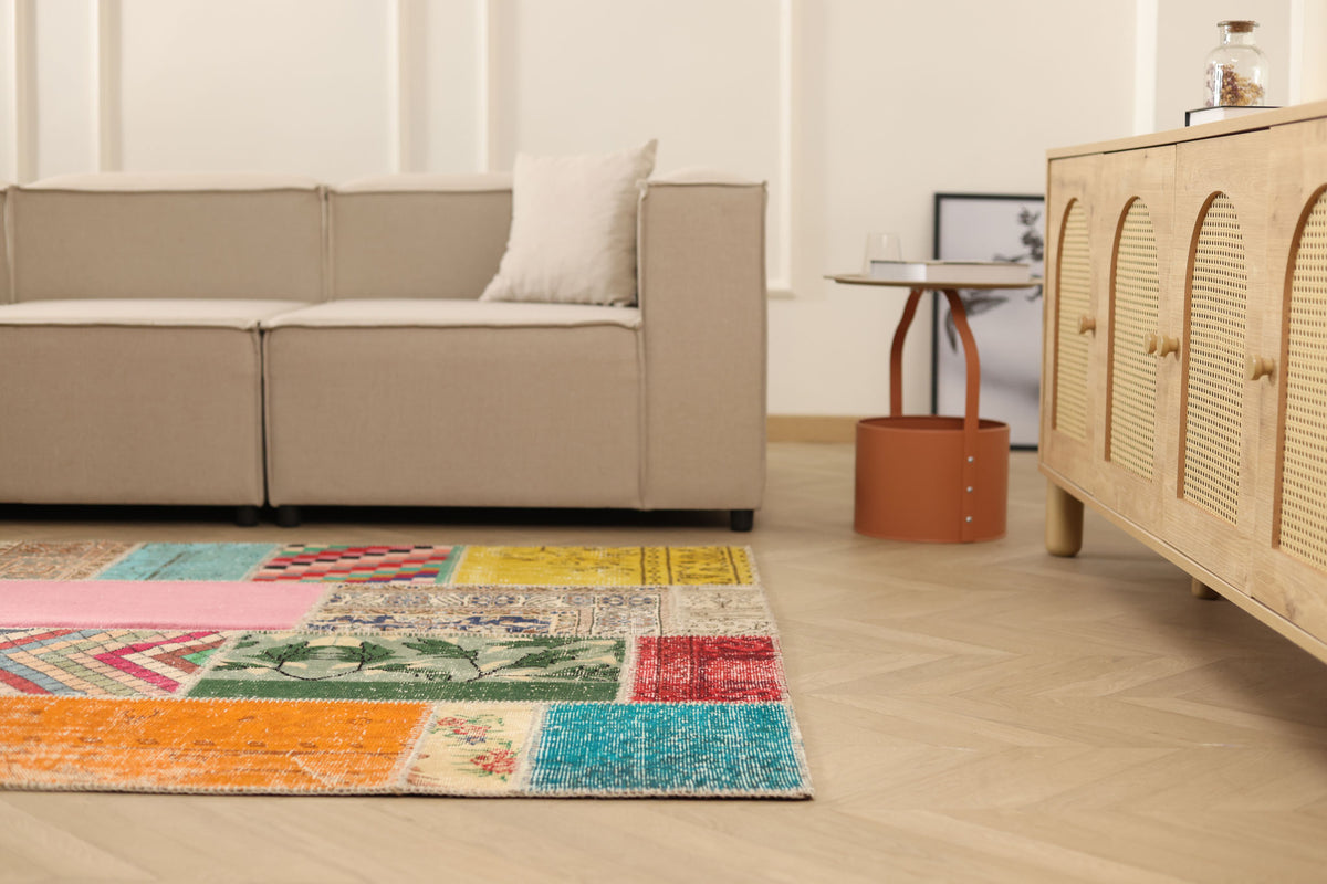 Handmade 5x7 ft vintage Turkish patchwork area rug with vibrant geometric patterns in wool and cotton.