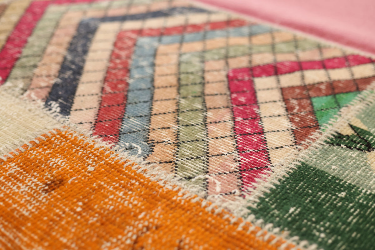 Handmade 5x7 ft vintage Turkish patchwork rug featuring colorful geometric patterns in wool and cotton.