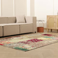 5x7 ft vintage Turkish patchwork area rug with vibrant floral patterns, hand-stitched wool and cotton in a bohemian living room.