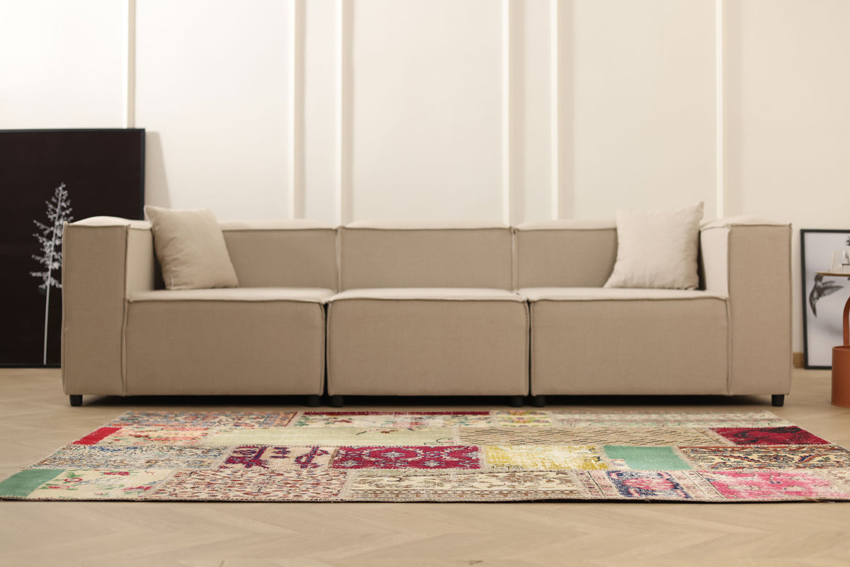 5x7 ft handmade Turkish patchwork area rug in wool and cotton with vibrant floral patterns in a bohemian living room.