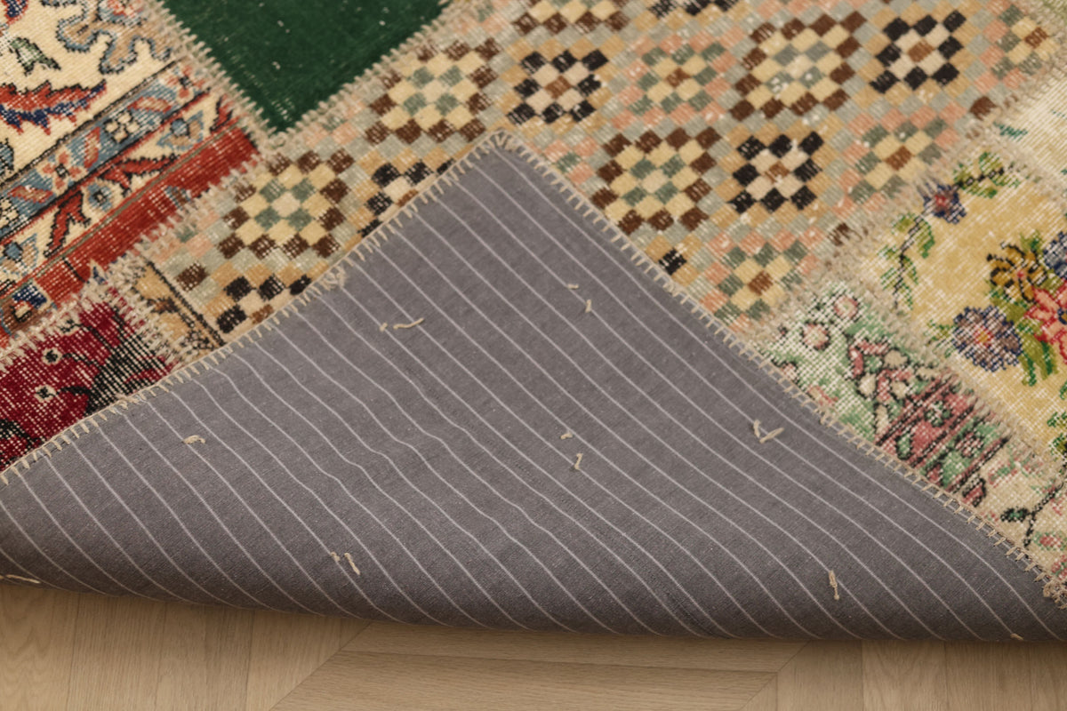 Handmade 5x7 ft vintage Turkish patchwork rug featuring colorful floral patterns and a grey striped fabric backing.