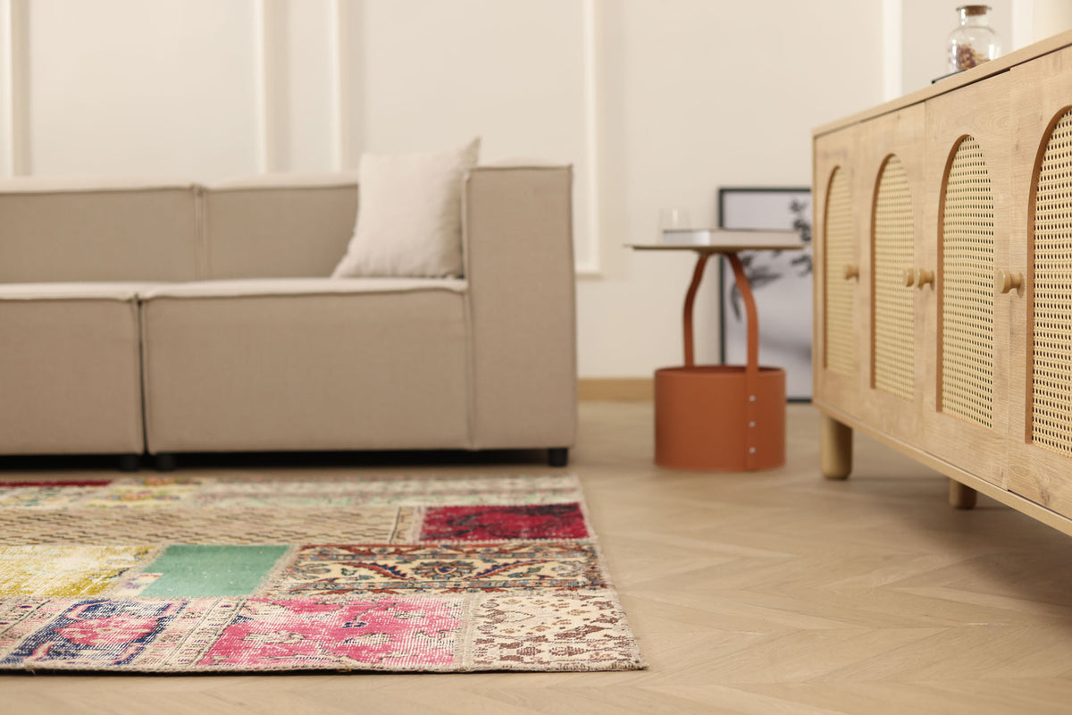 5x7 ft vintage patchwork Turkish area rug in wool and cotton with vibrant floral patterns in a bohemian living room.