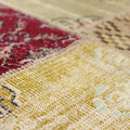 Handmade vintage Turkish patchwork rug featuring vibrant floral patterns in wool and cotton with a textured, eclectic design.