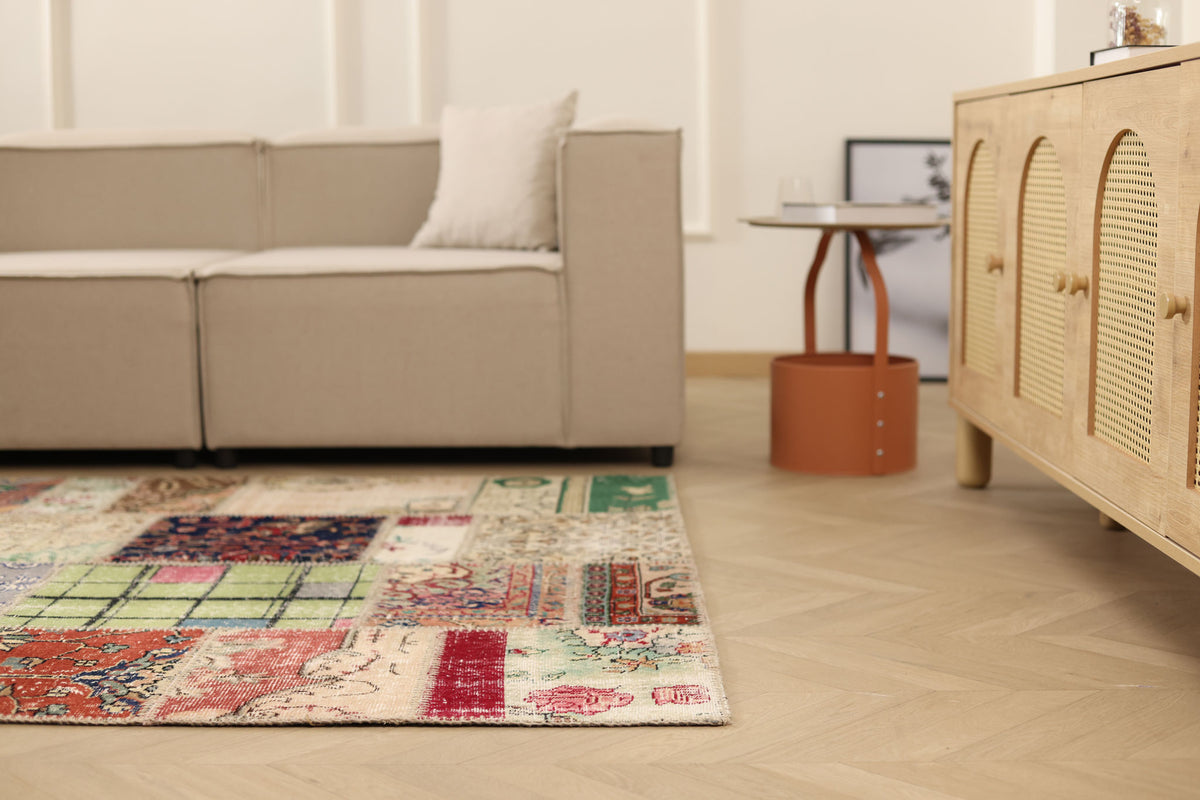 5x7 ft vintage Turkish patchwork area rug with vibrant floral patterns, hand-stitched wool and cotton in a bohemian room.