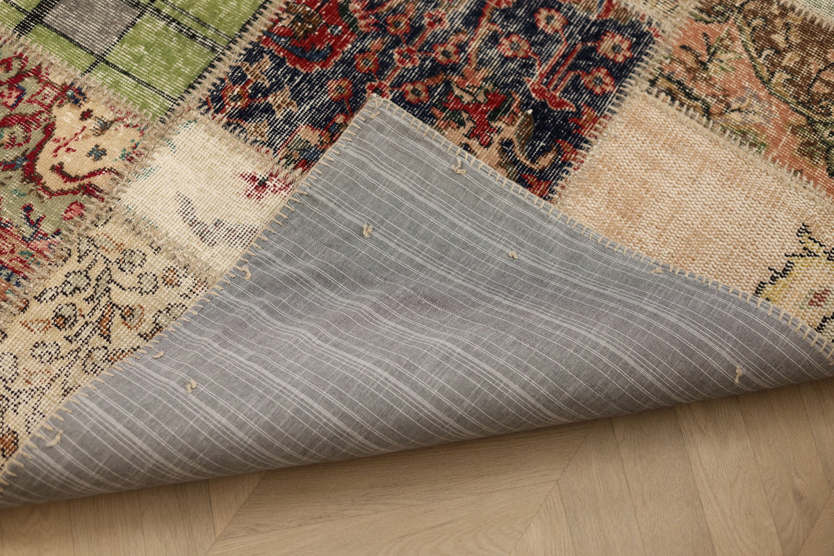 Handmade 5x7 ft vintage Turkish patchwork rug featuring colorful floral patterns and a durable fabric backing.