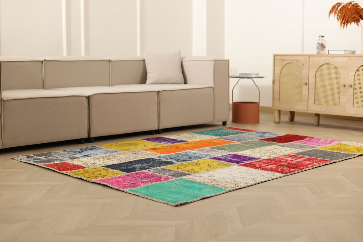 5x7 ft handmade Turkish patchwork area rug featuring vibrant, multi-colored floral wool and cotton squares.