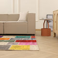 Multicolor patchwork vintage Turkish rug in wool and cotton, featuring vibrant floral patterns in a bohemian living room.