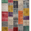 Handmade 5x7 ft vintage Turkish patchwork rug featuring vibrant, multi-colored floral wool and cotton panels.