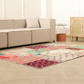 5x7 ft vintage Turkish patchwork area rug with vibrant floral patterns, hand-stitched wool and cotton in a bohemian living room.