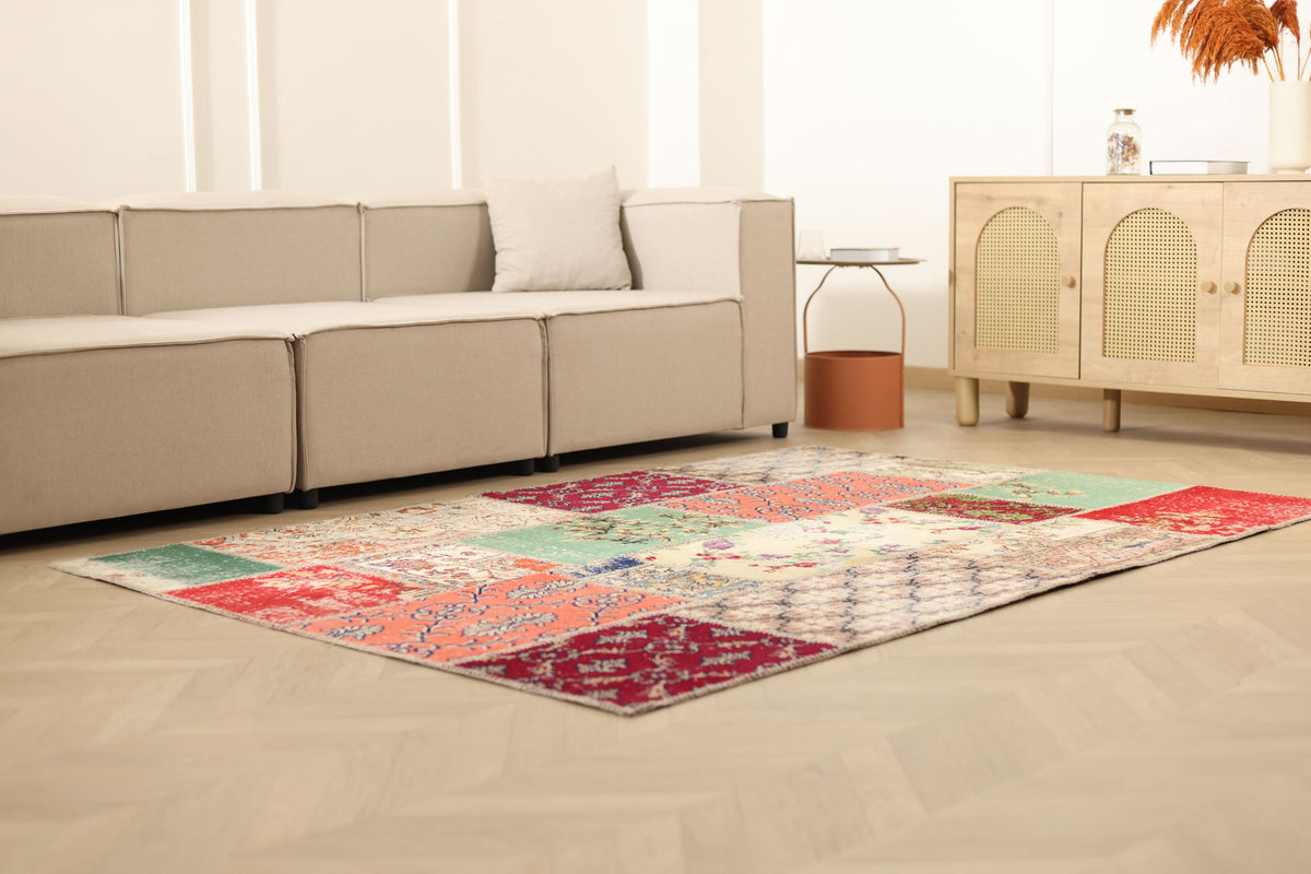 5x7 ft vintage Turkish patchwork area rug with vibrant floral patterns, hand-stitched wool and cotton in a bohemian living room.