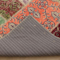 Vintage Turkish patchwork area rug with colorful floral patterns, wool and cotton construction, and a grey striped backing.