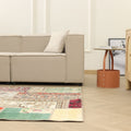Handmade 5x7 ft vintage Turkish patchwork rug with vibrant floral patterns in wool and cotton on a wooden floor.